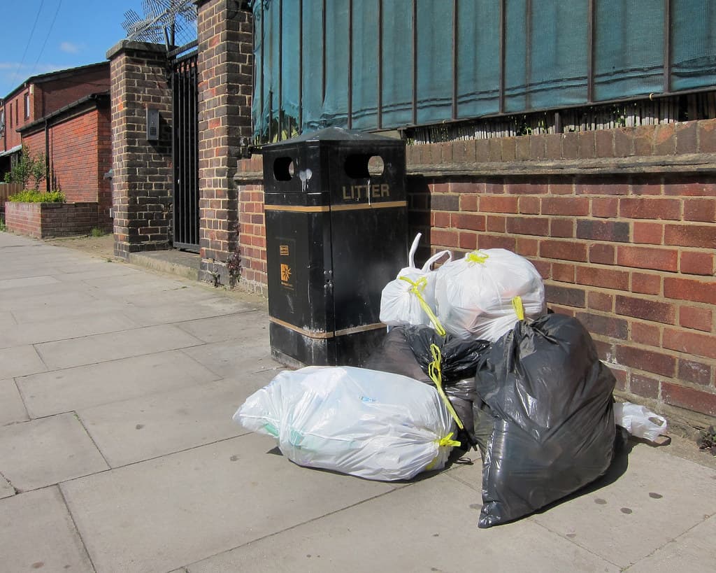 Heavy-duty tied garbage bags collected for industrial waste disposal
